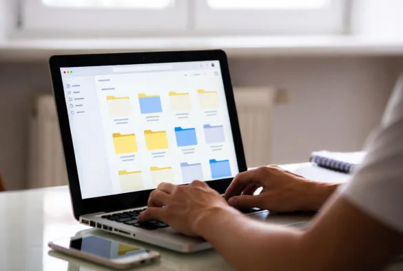 employee managing business files in cloud storage system on laptop