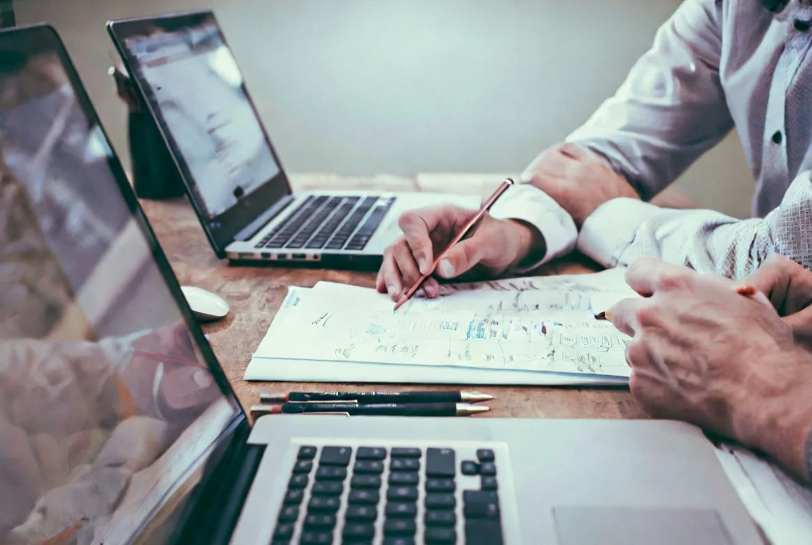 creating change management plan with notes and laptop