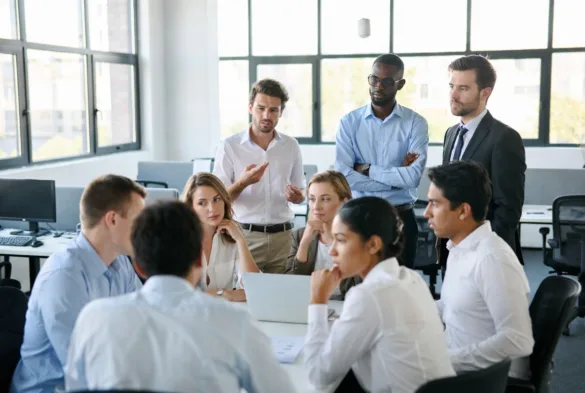 employees reacting to organizational change during team meeting